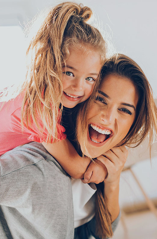 image of Young woman and small girl having a great time together