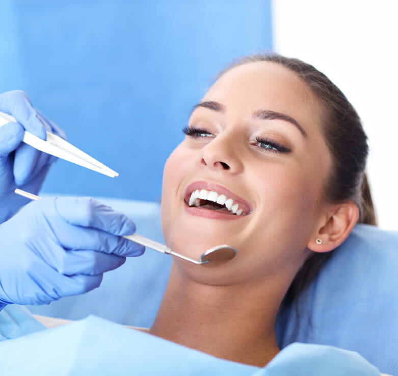 image of Woman having teeth examined at dentists
